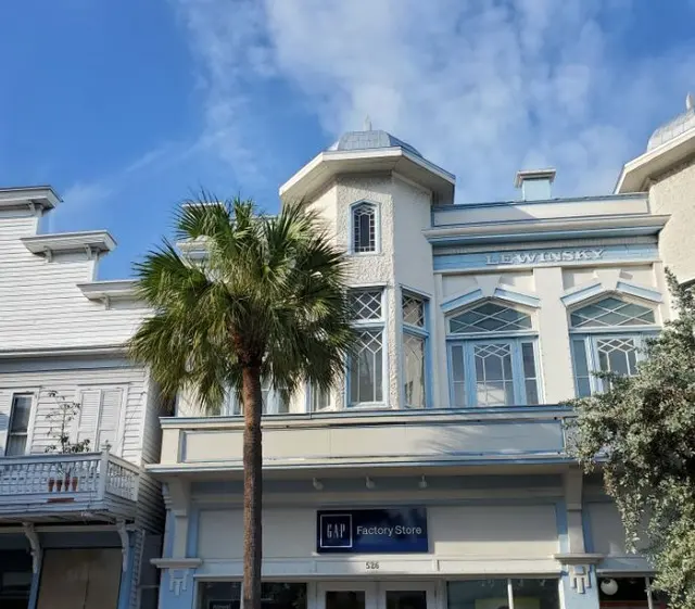 Historic Key West building facade with palm tree and Lewinsky Gap Factory Store sign; scenery