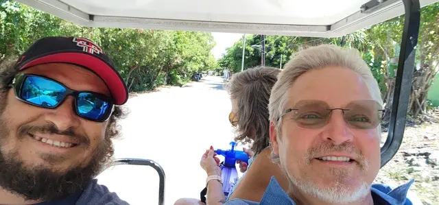 The whole crew together on the golf cart tour — John, Lori, and friends.