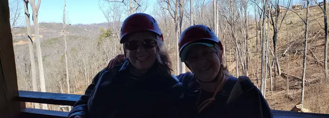 All smiles in helmets before zip-lining through the Smokies
