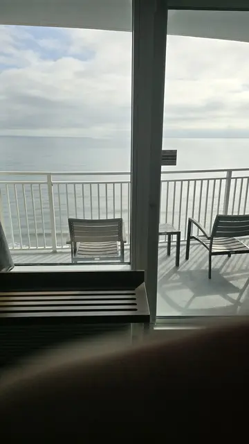 Arrival day - John taking in the ocean view from the balcony.