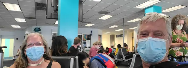 Masked up and all smiles at the airport, heading home