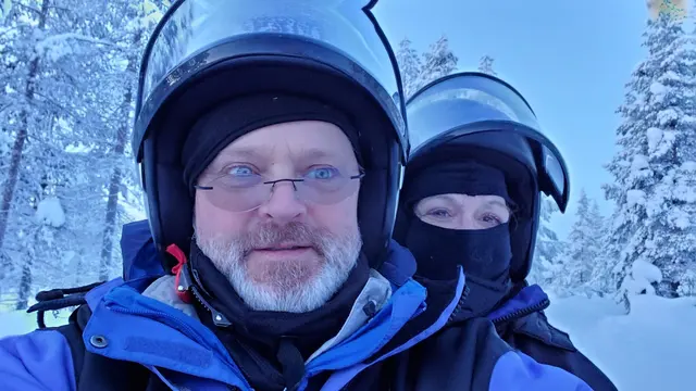 Bundled up for a snowmobile run through the woods