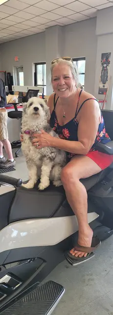 Lori with a friendly pup at a local motorcycle dealer before the trip north.