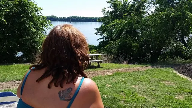 woman looking out at lake from picnic area
