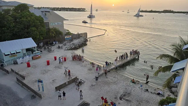 Crowds gather on the pier at Pier House to watch the sunset.
