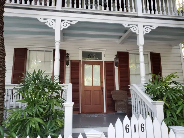 Classic Key West architecture - white picket fence and wraparound porch.