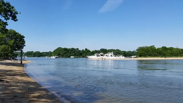 scenic river view with boats and trees