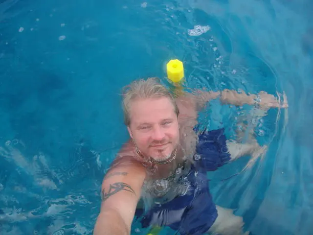 man swimming in pool selfie
