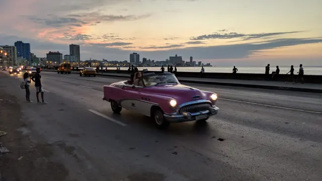 Close-up of a vintage green classic car at twilight