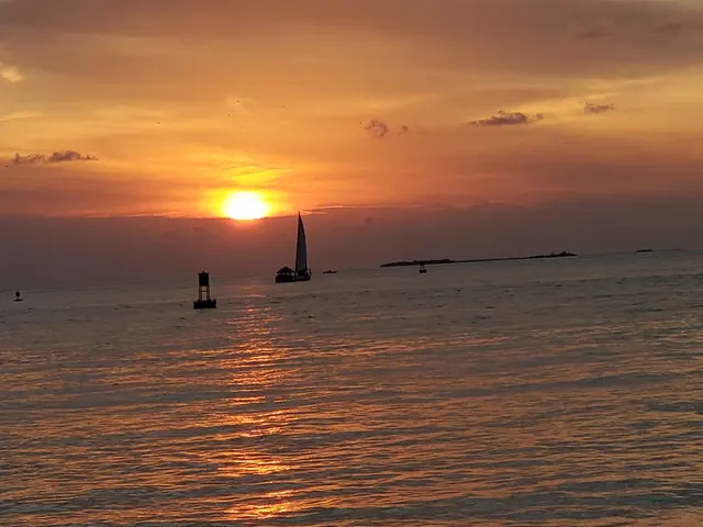 A sailboat silhouetted against a brilliant Key West sunset.