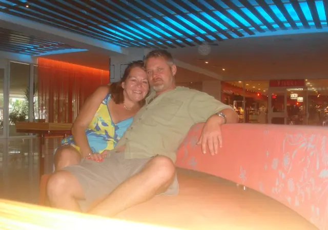 couple sitting together indoor lounge blue lighting