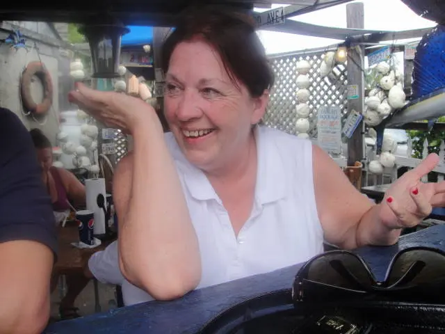 woman laughing at outdoor bar