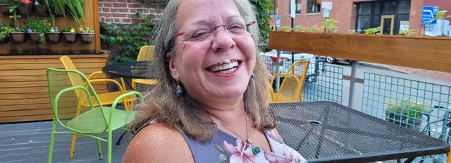 Lori sharing a laugh over dinner