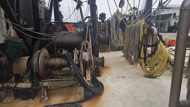 A working shrimp boat tied up in the harbor.