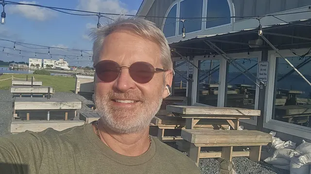 A sunny morning selfie at the waterfront before breakfast.