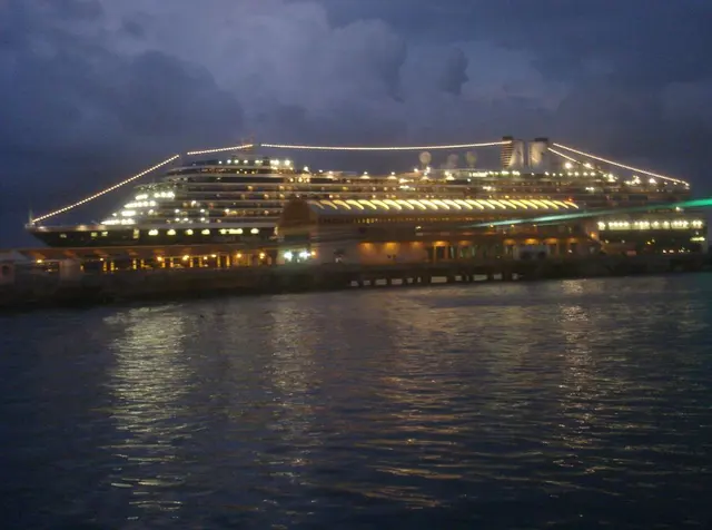 cruise ship at night docked lit up
