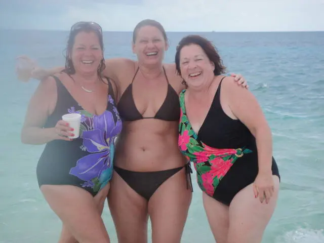 three women in swimsuits on beach