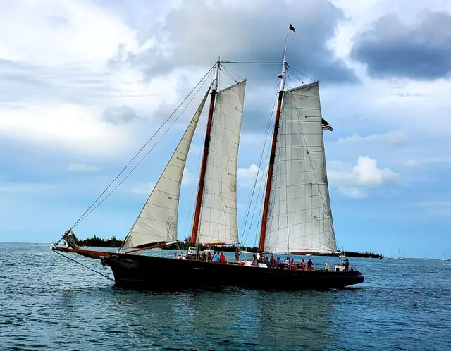 Tall ship schooner with sails up on the water; scenery