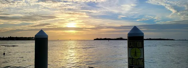 A tiki bar boat cruising by at golden hour