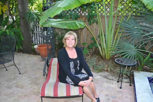 woman sitting on patio lounge chair in garden