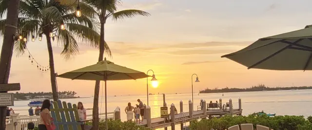 String lights and sunset colors over the water
