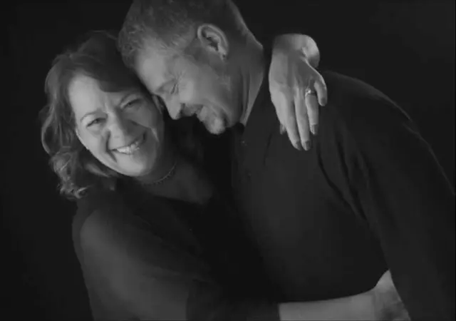 black and white studio portrait couple smiling clothed