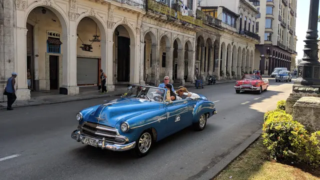 John and Lori cruising Havana in a classic blue convertible