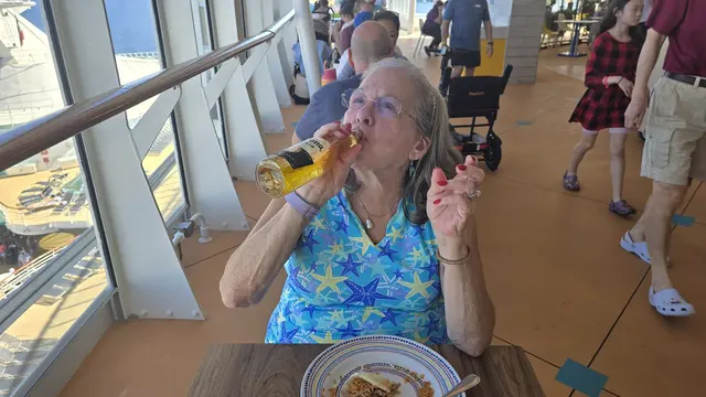 Lori enjoying a cold drink with lunch on deck.