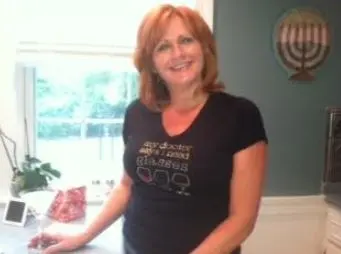 woman in kitchen wearing graphic t-shirt