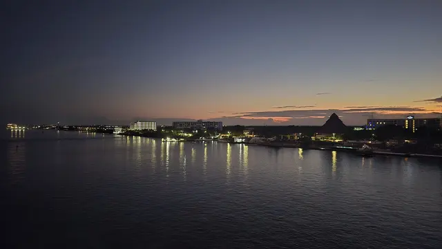 Dawn breaks over Cozumel, pyramid landmark in silhouette.