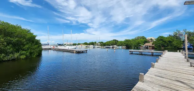 A quiet afternoon at the marina, boats bobbing under blue skies.