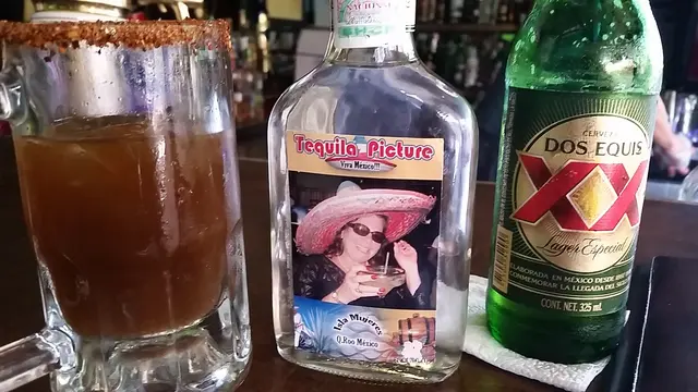 drinks on bar counter with tequila bottle photo label