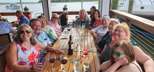 A wider look at the group enjoying dinner by the marina