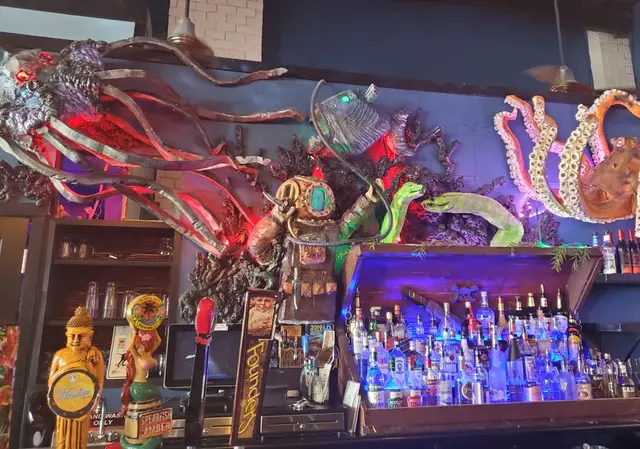 Bar interior with octopus and sea creature wall decor; scenery/decor