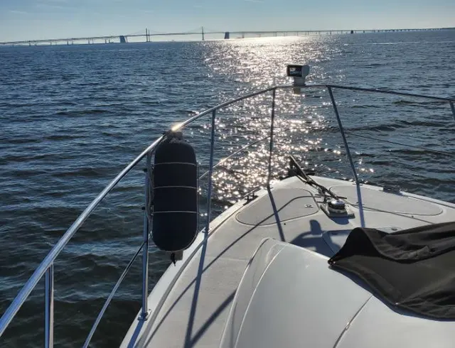 View of suspension bridge from boat bow; scenery