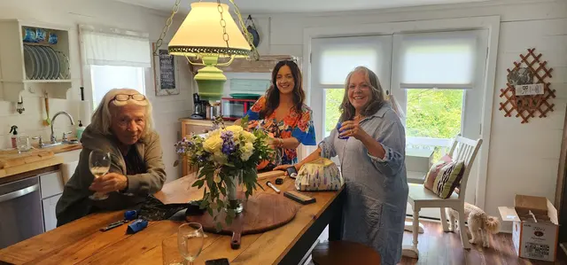 Wine and flowers with friends in the beach house kitchen