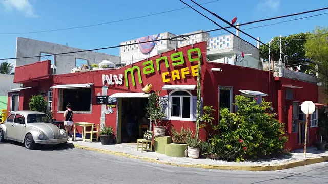 street view of colorful cafe with car