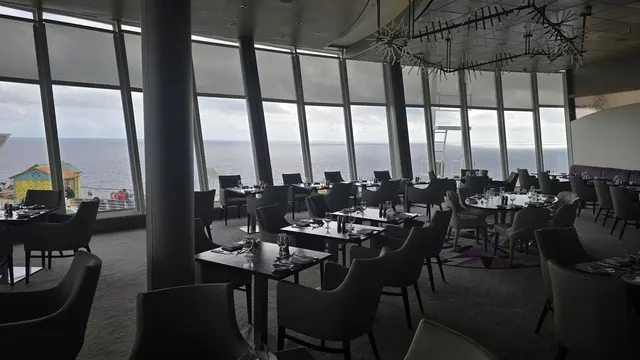 A quiet moment in the ship's specialty restaurant, ocean views all around.