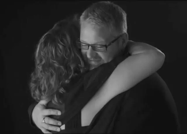 black and white studio portrait couple hugging clothed