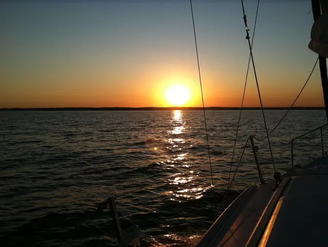 scenic sunset over water from sailboat