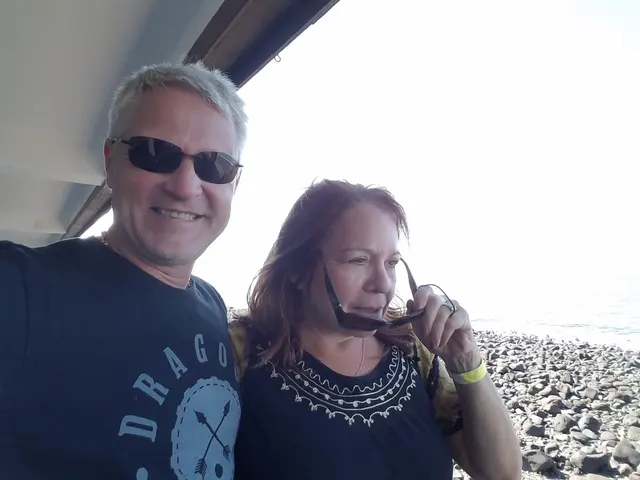 John and Lori at the water's edge under the pier