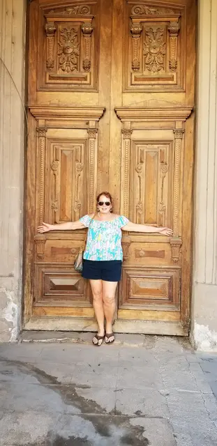 Posing at an ornate old wooden door in Old Havana