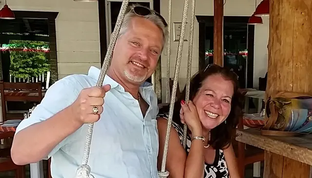 couple sitting on rope swing at restaurant