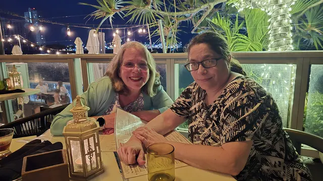 Dinner with friends at a rooftop restaurant overlooking the water.