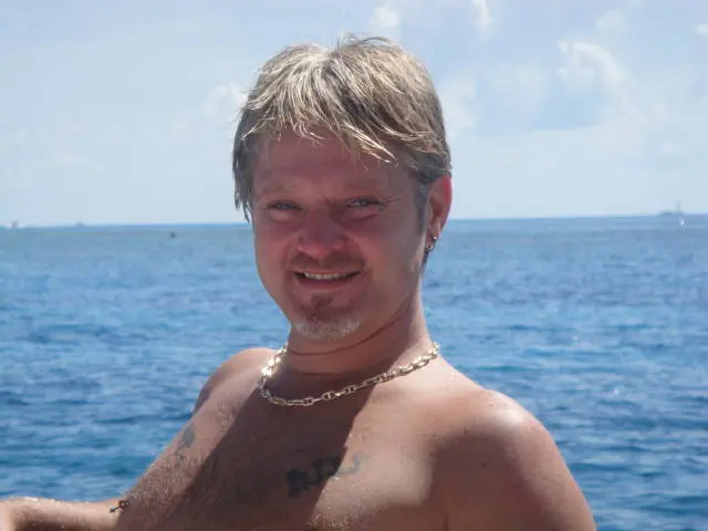 man smiling closeup on boat at sea