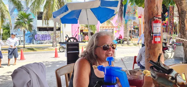 Sidewalk cafe stop, fresh drink in hand and sunglasses on.