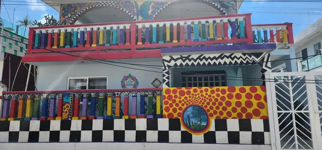 A vividly painted mural house lights up the neighborhood.