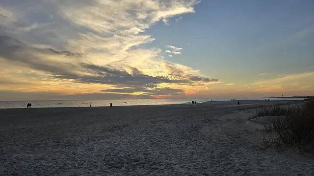 Golden hour silhouettes along the shore on Christmas Day.