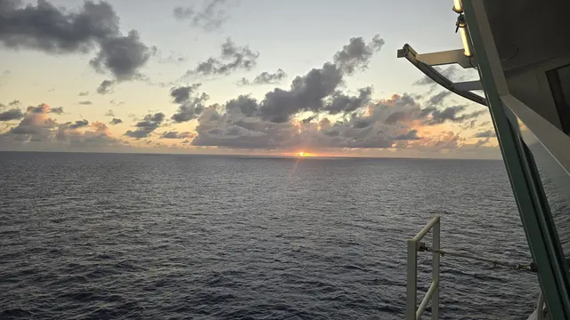 A fiery sunset over calm seas.