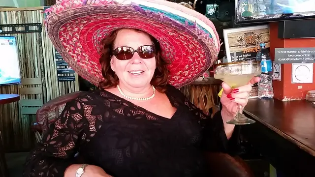 woman in sombrero with margarita at bar